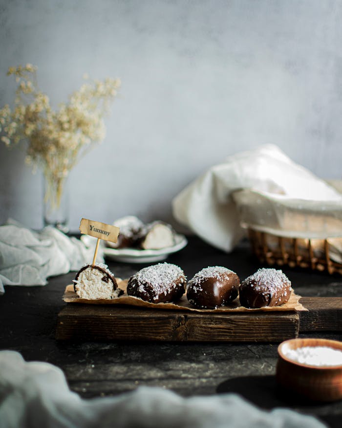 Services Enticing chocolate-covered pastries on a rustic tray, perfect for dessert lovers.