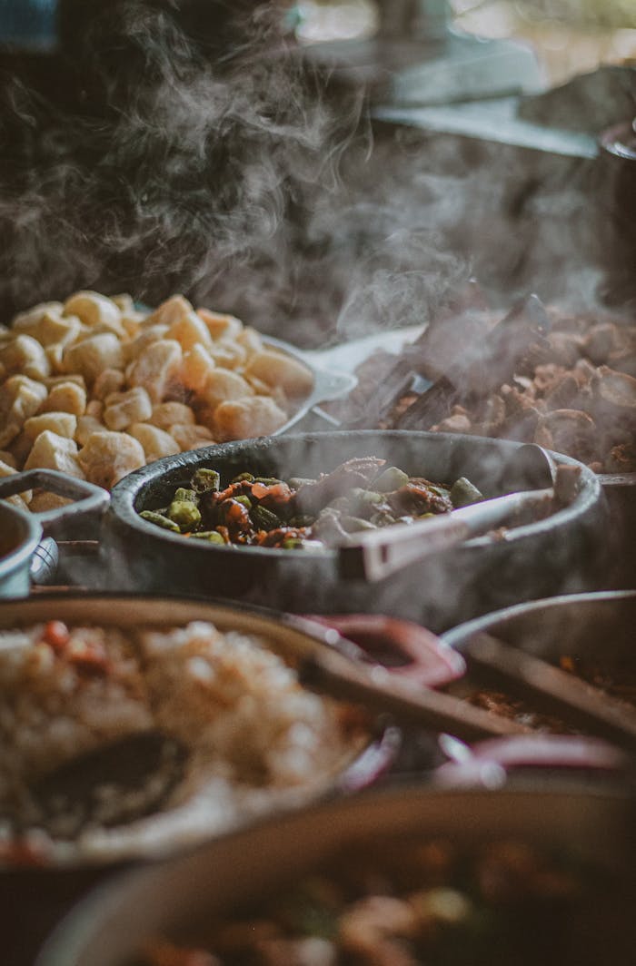 Services Close-up of a steaming buffet with diverse dishes, showcasing an appetizing variety of food.